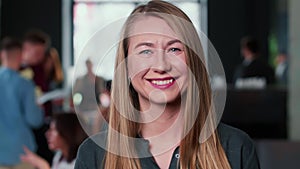 Portrait of beautiful young 30s successful blonde business woman cheerfully smiling at camera at trendy light coworking.