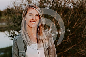 Portrait of Beautiful Young Adult Professional Female Woman Fashion Model Person Smiling Outside at the Park in Nature with Natura