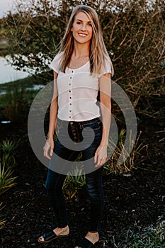 Portrait of Beautiful Young Adult Professional Female Woman Fashion Model Person Smiling Outside at the Park in Nature with Natura