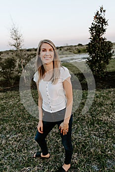 Portrait of Beautiful Young Adult Professional Female Woman Fashion Model Person Smiling Outside at the Park in Nature with Natura