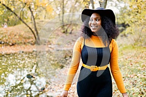 Portrait of a beautiful young african american woman smiling and staying outdoors