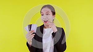 Portrait beautiful young asian business woman hold credit card or debit card for shopping payment.