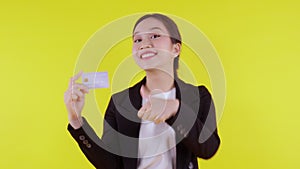 Portrait beautiful young asian business woman hold credit card or debit card for shopping payment.