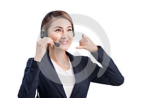 Portrait of beautiful young asian female customer service representative in headset looking at camera and smiling while isolated