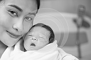 Portrait of beautiful young asian mother with her new born baby