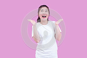 Portrait of beautiful Young Asian woman black hair wear a white t-shirt with open hand and surprised excited happy screaming.