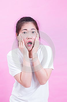 Portrait of beautiful Young Asian woman black hair wear a white t-shirt. with shocked facial expression.