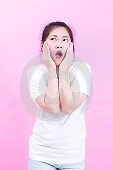 Portrait of beautiful Young Asian woman black hair wear a white t-shirt. with shocked facial expression.