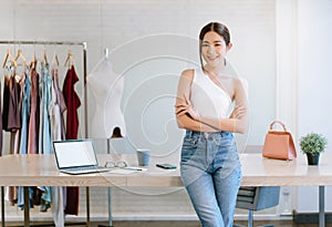 Portrait of beautiful young Asian woman fashion designer working small business owner standing with arms crossed in luxury