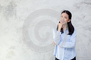Portrait of beautiful young asian woman happiness standing on gray cement texture grunge wall background