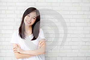 Portrait of beautiful young asian woman happiness standing on gray cement texture grunge wall brick background.