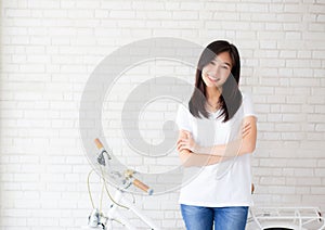 Portrait of beautiful young asian woman happiness standing on gray cement texture grunge wall brick background.