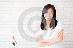 Portrait of beautiful young asian woman happiness standing on gray cement texture grunge wall brick background.