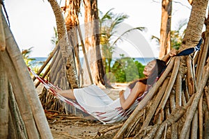 Portrait beautiful young asian woman happy smile leisure on hammock swing around the beach sea and ocean with blue sky white cloud