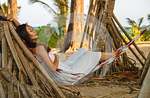 Portrait beautiful young asian woman happy smile leisure on hammock swing around the beach sea and ocean with blue sky white cloud