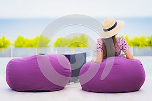 Portrait beautiful young asian woman looking at sea ocean with happy smile for relax leisure in vacation