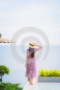 Portrait beautiful young asian woman looking at sea ocean with happy smile for relax leisure in vacation