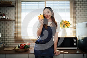 Portrait of beautiful young asian woman making salad at home. cooking food and Lifestyle moment