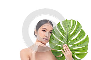 Portrait of beautiful young Asian woman with perfect body smooth skin beauty face natural make up in tropical green leaves