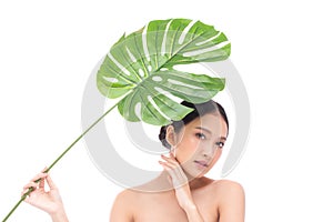 Portrait of beautiful young Asian woman with perfect body smooth skin beauty face natural make up in tropical green leaves