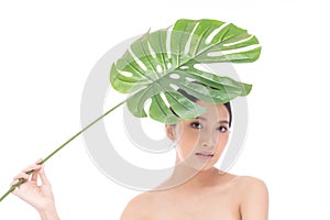 Portrait of beautiful young Asian woman with perfect body smooth skin beauty face natural make up in tropical green leaves