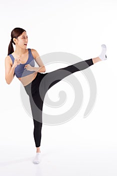 Portrait beautiful young asian woman in sportwear workout with kick and exercise isolated on white background.