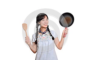 Portrait of beautiful young asian woman wear denim dress with black pan and spatula on white isolated background