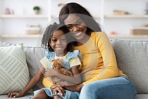 Portrait Of Beautiful Young Black Mom And Female Child Posing At Home