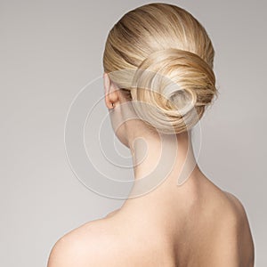 Portrait Of A Beautiful Young Blond Woman With Bun Hairstyle.