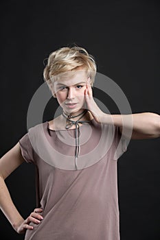 Portrait of a beautiful young blond woman wearing fashion statement necklace
