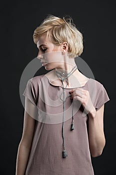 Portrait of a beautiful young blond woman wearing fashion statement necklace