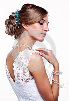 Portrait of beautiful young blonde woman bride in white Wedding