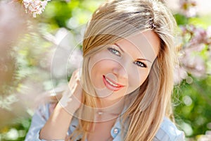 Portrait of a beautiful young blonde woman with long hair in a b