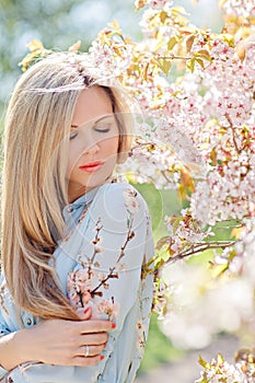 Portrait of a beautiful young blonde woman with long hair in a b