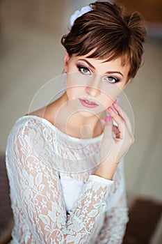 Portrait of beautiful young brown-haired woman in white dress