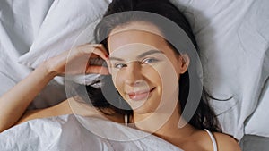 Portrait of Beautiful Young Brunette Charmingly Sleeping in Her Bed at Night in the Dark Room. Swe