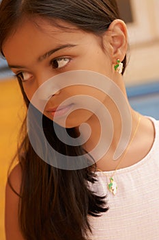 Portrait of beautiful young brunette girl with dark long hair