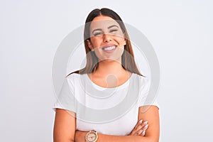 Portrait of beautiful and young brunette woman standing over isolated white background happy face smiling with crossed arms