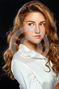 Portrait beautiful young brunette woman with wavy hair in white