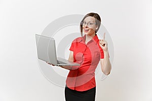 Portrait of beautiful young business teacher woman user in red shirt, glasses working typing on laptop pc computer