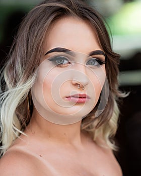 Portrait of Beautiful Young Caucasian Girl with Barbell septum Nose Ring. Horseshoe Nose Ring
