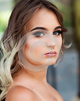 Portrait of Beautiful Young Caucasian Girl with Barbell septum Nose Ring. Horseshoe Nose Ring