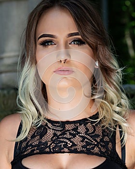 Portrait of Beautiful Young Caucasian Girl with Barbell septum Nose Ring. Horseshoe Nose Ring