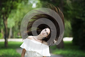 Portrait of a beautiful young caucasian woman with flying long hair, clean skin and casual makeup