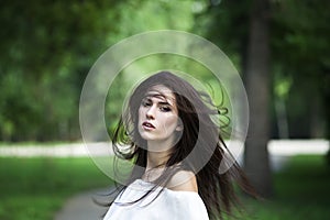 Portrait of a beautiful young caucasian woman with flying long hair, clean skin and casual makeup