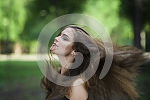 Portrait of a beautiful young caucasian woman with flying long hair, clean skin and casual makeup