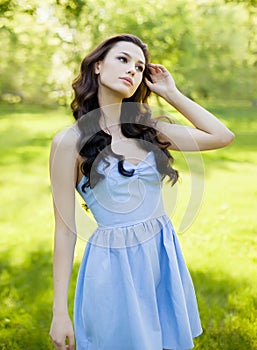 A portrait of a beautiful young caucasian woman outdoor. Soft sunny colors.