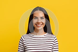 Portrait Of Beautiful Young Caucasian Woman Posing Over Yellow Background