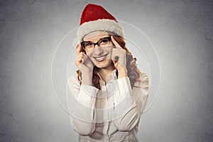 Portrait beautiful young christmas girl with glasses wearing santa claus clothes