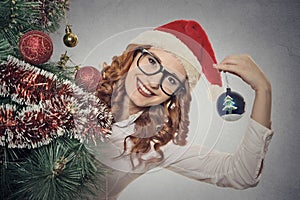 Portrait beautiful young christmas girl with glasses wearing santa claus clothes